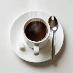 Bria FIBO — A cup of coffee on a saucer, with a spoon to the r