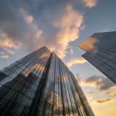 FLUX.2 [dev] — A modern glass skyscraper reflecting clouds at sun