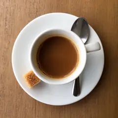 FLUX.2 [dev] — A cup of coffee on a saucer, with a spoon to the r