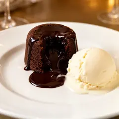 FLUX.2 [dev] — A dripping chocolate lava cake cut open on a white