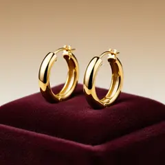 FLUX.2 [flex] — A pair of gold hoop earrings on a velvet jewelry d