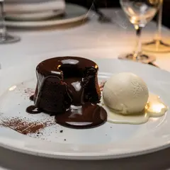 FLUX.2 [max] — A dripping chocolate lava cake cut open on a white