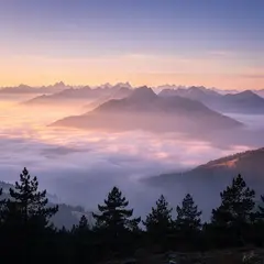 FLUX.2 [max] — A misty mountain range at sunrise, layers of purpl