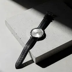 FLUX.2 [max] — A minimalist wristwatch with a black leather strap