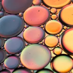 FLUX.2 [pro] — A macro photograph of oil droplets on water, iride
