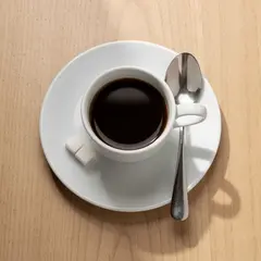 FLUX.2 [pro] — A cup of coffee on a saucer, with a spoon to the r