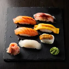 FLUX.2 [pro] — A perfectly plated sushi omakase on a black slate 
