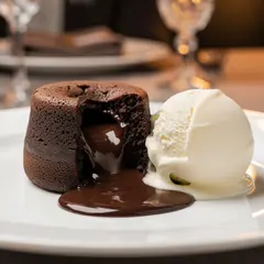 FLUX.2 [pro] — A dripping chocolate lava cake cut open on a white