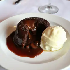 FLUX.1 [schnell] — A dripping chocolate lava cake cut open on a white