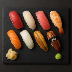 GPT Image 1 Mini — A perfectly plated sushi omakase on a black slate 