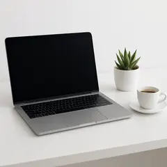 GPT Image 1 Mini — A sleek laptop on a clean white desk with a potted