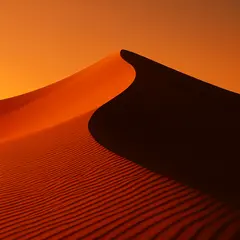 GPT Image 1 — A desert sand dune at sunset with long shadows, Sa