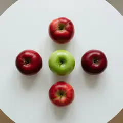 Grok Imagine — Five red apples arranged in a circle on a white ta