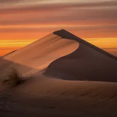 Ideogram V3 Turbo — A desert sand dune at sunset with long shadows, Sa