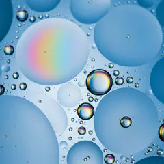 Imagen 4 Fast — A macro photograph of oil droplets on water, iride
