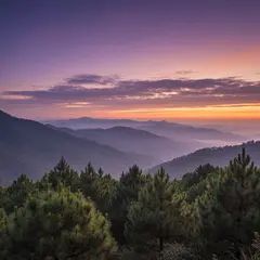 Imagen 4 Fast — A misty mountain range at sunrise, layers of purpl