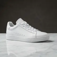 Imagen 4 Fast — A pair of white leather sneakers on a marble count