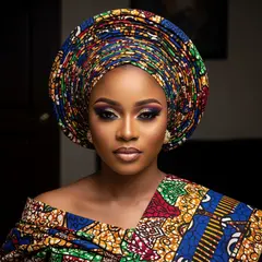 Imagen 4 Ultra — A woman with elaborate gele headwrap and bold eye 