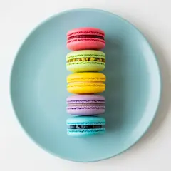 Imagen 4 Ultra — A stack of colorful macarons on a pastel blue plat