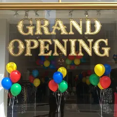 Imagen 4 — A storefront window with GRAND OPENING painted in 