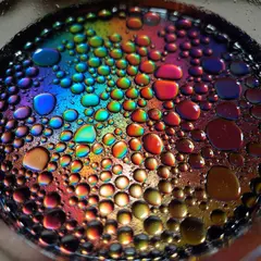ImagineArt 1.5 — A macro photograph of oil droplets on water, iride