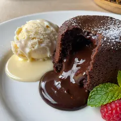 ImagineArt 1.5 — A dripping chocolate lava cake cut open on a white