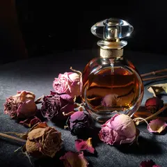 ImagineArt 1.5 — A bottle of amber perfume on a bed of dried roses,
