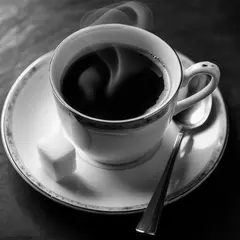 Luma Photon — A cup of coffee on a saucer, with a spoon to the r