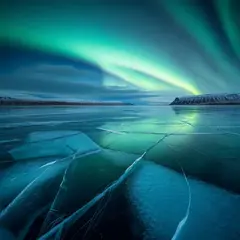 Luma Photon — A frozen lake with cracks in the ice, Northern Lig