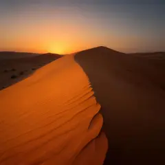 Luma Photon — A desert sand dune at sunset with long shadows, Sa