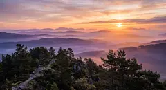 Gemini 3.1 Flash Image — A misty mountain range at sunrise, layers of purpl