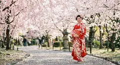 Gemini 3.1 Flash Image — A Japanese woman in a red kimono standing under ch