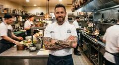 Gemini 3.1 Flash Image — A tattooed chef in a white coat, arms crossed, con