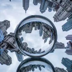 Gemini 3 Pro Image — A glass sphere refracting a distorted cityscape, s