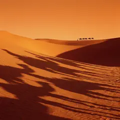 Gemini 3 Pro Image — A desert sand dune at sunset with long shadows, Sa