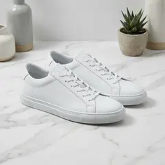 Gemini 3 Pro Image — A pair of white leather sneakers on a marble count
