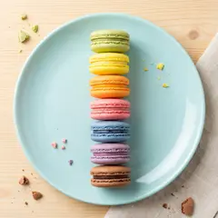 Gemini 3 Pro Image — A stack of colorful macarons on a pastel blue plat