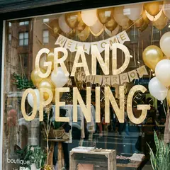 Gemini 3 Pro Image — A storefront window with GRAND OPENING painted in 