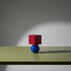 Gemini 2.5 Flash Image — A red cube on top of a blue sphere, both sitting o
