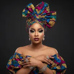 Gemini 2.5 Flash Image — A woman with elaborate gele headwrap and bold eye 