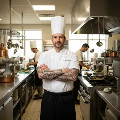 Gemini 2.5 Flash Image — A tattooed chef in a white coat, arms crossed, con