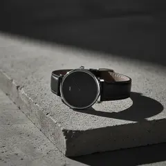 Gemini 2.5 Flash Image — A minimalist wristwatch with a black leather strap