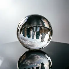 Qwen Image 2.0 — A glass sphere refracting a distorted cityscape, s