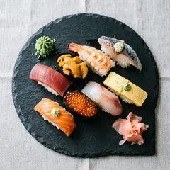 Qwen Image 2.0 — A perfectly plated sushi omakase on a black slate 