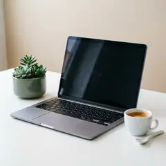 Qwen Image 2.0 — A sleek laptop on a clean white desk with a potted