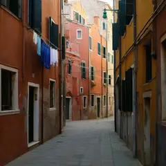 Qwen Image — A narrow cobblestone alley in Venice with colorful