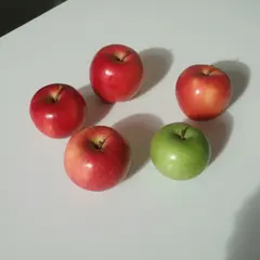 Qwen Image — Five red apples arranged in a circle on a white ta
