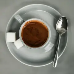 Qwen Image — A cup of coffee on a saucer, with a spoon to the r