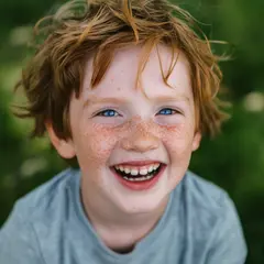 Qwen Image — A freckled boy with bright blue eyes and messy hai