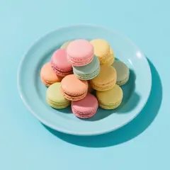 Qwen Image — A stack of colorful macarons on a pastel blue plat